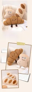 Gros plan d'oreillers en peluche en forme de pain avec visages brodés sur un canapé