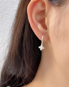 Detailed view of S925 sterling silver hoop earring with sparkling pavé flower charm