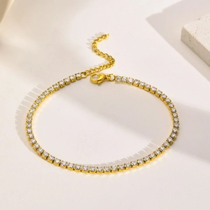 Detail of gold-plated tennis bracelet with pavé-set white cubic zirconia and lobster clasp