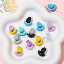 Macro detail of tulip shaped colorful acrylic beads for DIY jewelry making in a white tray