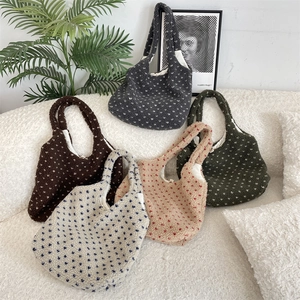 Close-up of five heart-patterned sherpa tote bags in diverse colors for winter