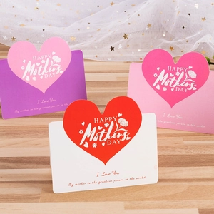 Detailed macro view of Mother's Day cards with heart die-cuts on a wooden surface