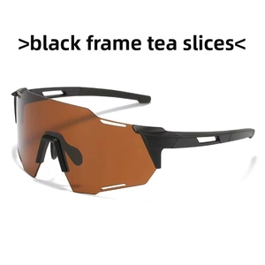 Close-up of professional sports sunglasses with black frames and tea-tinted lenses