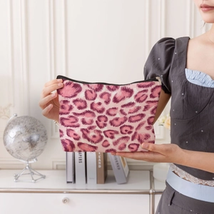 Handheld pink leopard print canvas makeup bag with black zipper for travel storage