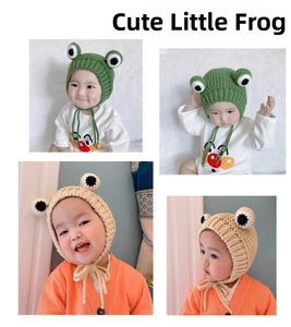 Detail of baby knit hat featuring 3D frog eyes design and adjustable chin straps