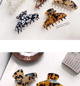 Close-up of small leopard print acetate hair claws in various patterns on clean background