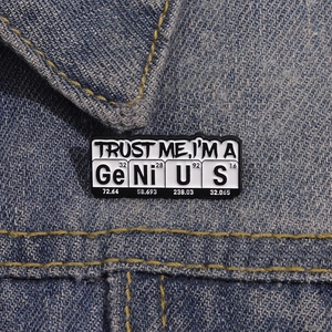 Trust Me I'm a Genius chemistry enamel pin with periodic table elements on denim
