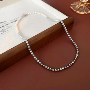 Detail view of French minimalist pearl necklace with elegant white to grey gradient beads