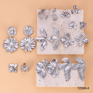 Chunky silver sunflower and daisy titanium steel earrings set on marble stone