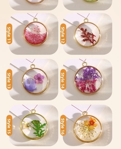 Detail view of handmade resin dried flower pendants in gold frames, styles 11-16