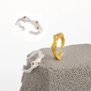 Irregular bark texture S925 silver open ring with orange zircons on a grey stone
