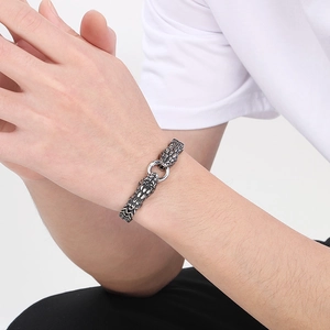Close-up of vintage silver dragon head bracelet with twin links and ring clasp