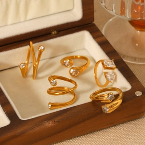 Set of five 18K gold-plated stainless steel rings with zircon stones in a wooden jewelry box