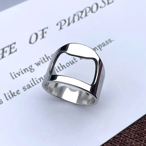 Macro shot of silver stainless steel bottle opener ring on decorative white card