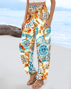 Close-up of high-waist mandala print trousers with soft draped fabric on beach setting