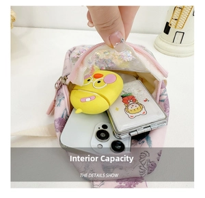 Detail showing inner capacity of pink floral canvas crossbody bag with daily essentials