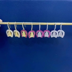 Detail of Virgin Mary hoop earrings with colorful zircon stones on gold and silver plating