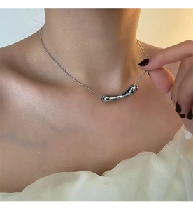 Detailed close-up of a liquid-style irregular pendant on a sleek silver titanium steel chain
