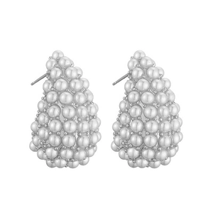 Macro detail of tear-drop cluster earrings featuring elegant white pearls on silver studs