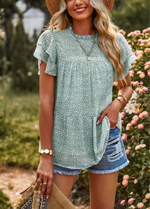 Detail of ruffle butterfly sleeves and green polka dot pattern on women's floral summer tee