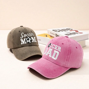 Detail of embroidered SOCCER MOM and DAD baseball caps in washed cotton fabric