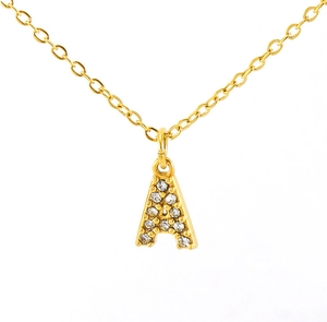 Macro shot of gold letter A pendant with sparkling pavé-set crystals on a sleek chain