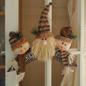 Charming Merry Christmas snowman and Santa plush ornaments hanging on a white wooden window