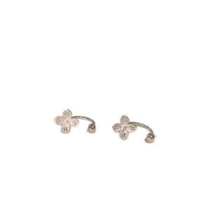 Elegant silver hollow four-petal flower ear clips featuring delicate engraved textures