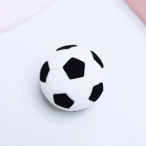 Close-up of football shaped velvet jewelry box in classic black and white plush