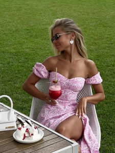 Detail of pink floral off-shoulder dress with puff sleeves and heart-shaped neckline