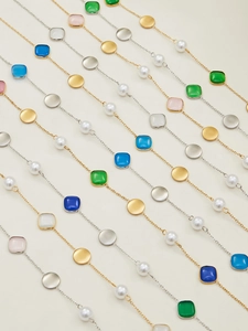 Detail of colorful opal beads and gold-plated metal discs on women's collar necklace