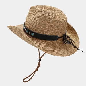 Detail of western straw hat with turquoise studs and woven texture for beach sun protection