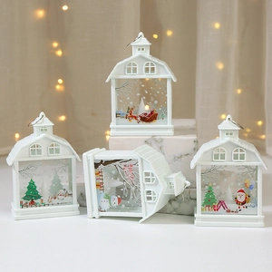 White LED Christmas lantern house with festive Santa and reindeer designs for decor