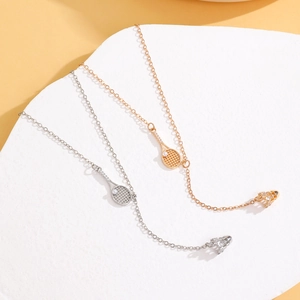 Macro detail of tennis racket pendant necklaces with pavé zircon stones in gold and silver