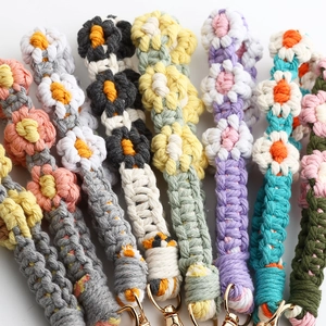 Detail of colorful hand-woven daisy floral wristlet straps with gold metal clasps