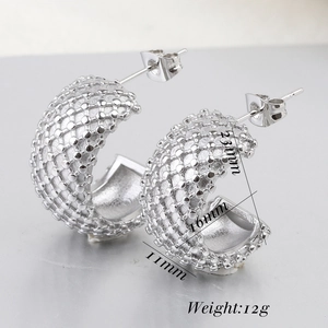 Macro detail of silver stainless steel C-hoop earrings with beaded texture and dimensions