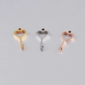 Three heart-shaped key pendants in gold, silver and rose gold for DIY jewelry making