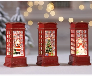 Close-up of red Christmas telephone booth lanterns with Santa, tree and snow motifs