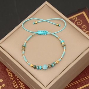 Detailed shot of handmade bohemian turquoise beaded bracelet with blue woven cord