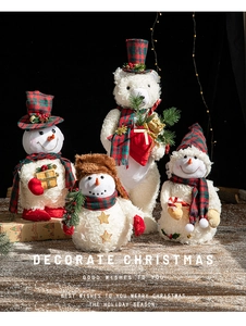Detailed Christmas plush display with snowman and bear figures in red plaid holiday outfits