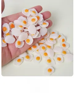 Detailed view of miniature PVC fried egg models for dollhouse food craft and DIY decor