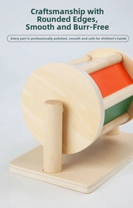Close-up of spinning drum wooden toy featuring smooth rounded edges and colorful panels