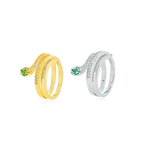 Macro detail of snake-shaped ring with emerald green zircon eyes and bicolor metal finish
