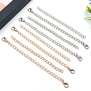 Detailed view of gold and silver extension chains with lobster clasps for jewelry making