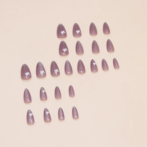 Almond-shaped cat eye fake nails in sheer purple with butterfly pattern and silver glitter