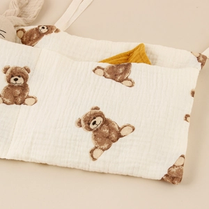 Close-up of soft muslin cotton storage bag with cute vintage brown teddy bear prints