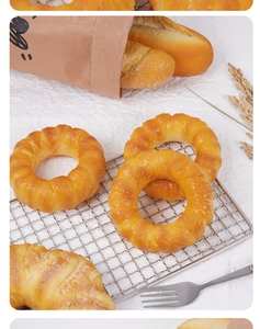 Realistic PU slow-rebound donut and bread models on cooling rack with rustic props