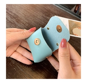 Macro shot of light blue lychee pattern leather mini pouch with metal magnetic buckle