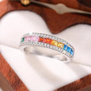 Rainbow gemstone eternity ring with colorful square zircons in a heart-shaped wooden box