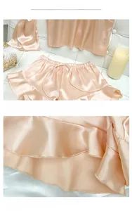 Detail shot of ruffle hem on champagne satin camisole and shorts sleepwear set